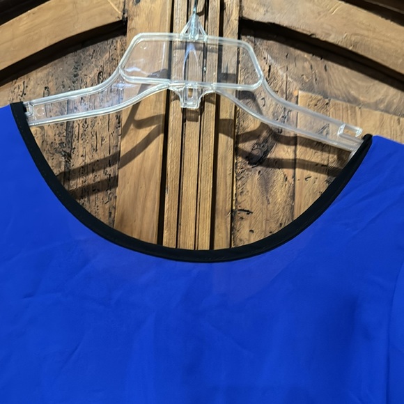 Sheer bright blue top with black bows on back. It’s a large by Agaci. - Picture 3 of 5